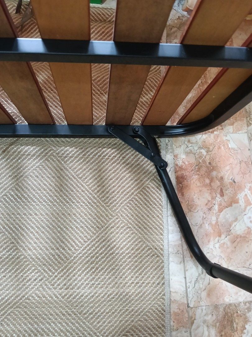 Folding Bed Frame with Wooden Slats (Category: Bed Frames & Mattresses) located in Las Pinas. Submitted by pasculadon06101 (Listing ID 1394036352, Image 3). Description: - Single-sized folding bed frame - Sturdy metal frame - Wooden slats for mattress support and ventilation - Folds up for compact storage - Black metal finish - Ideal for guest rooms or small spaces.