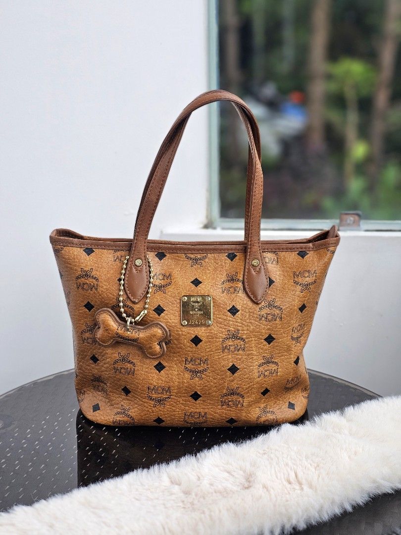 MCM Visetos Cognac Mini Tote (Category: Luxury Bags & Wallets) located in Baguio. Submitted by kayeonlineshop (Listing ID 1394083735, Image 1). Description: 👜 Mini MCM 👜 Via Measuring Tape: H (8"), L (9.5"), W (5") 👜 With signs of use (kunting cracked sa lips ng bag, may rubs sa ilalim ng bag) 👜 Pre-owned Authentic 👜 Zip closure 📌 Shipping via J&T (no to COD) 🏷 MOP: G-cash / Bank transfer.