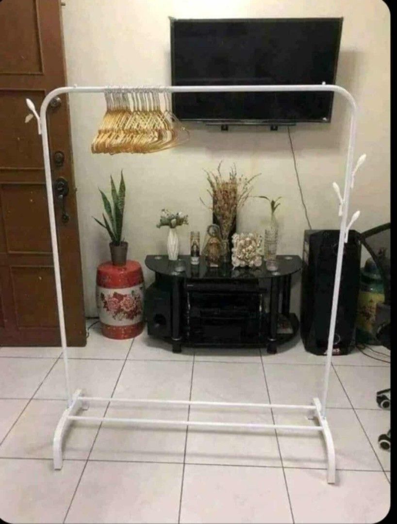 White Clothes Rack (Category: Clothes Drying Rack) located in Manila. Submitted by nixdcruz (Listing ID 1394151319, Image 1). Description: - White clothes rack - Top bar for hanging clothes - Lower bar for extra storage - Curved legs - Side hooks for added convenience - Sturdy design - Perfect for bedrooms or laundry areas.