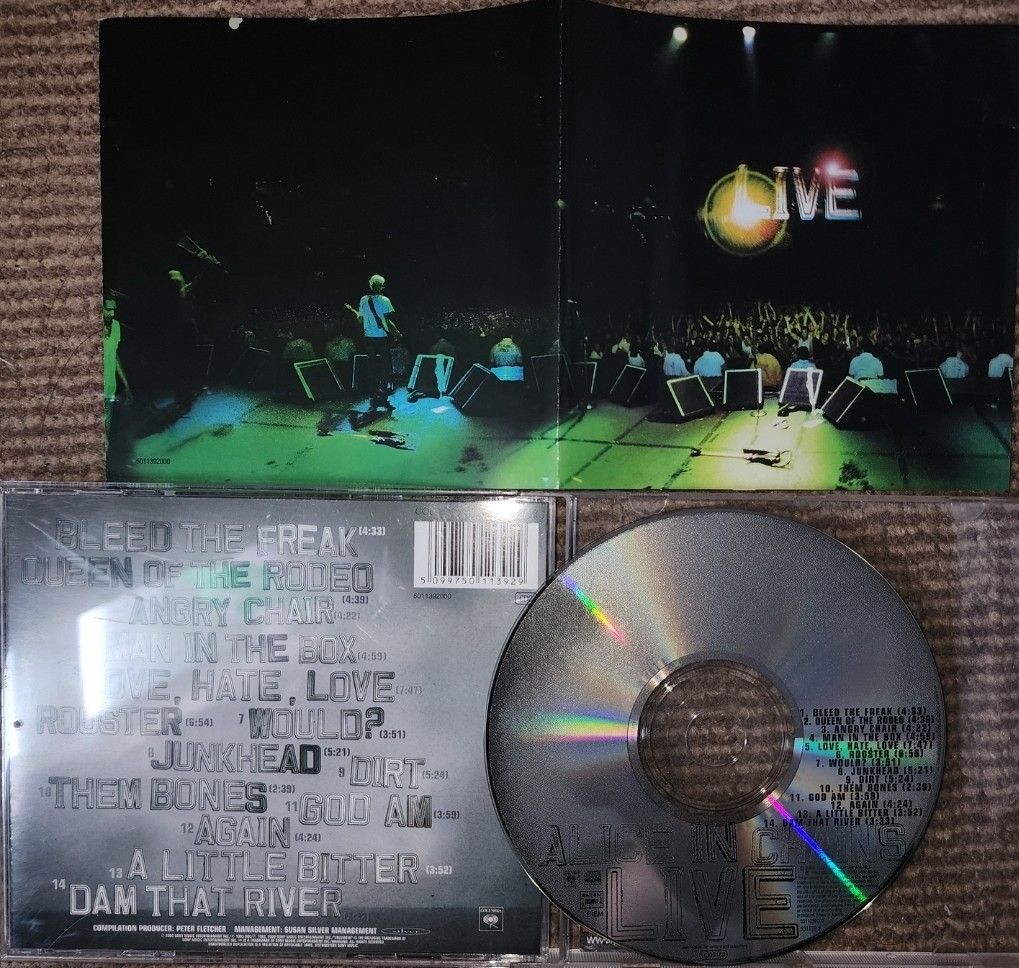 Alice in Chains - Live (Category: CDs & DVDs) located in Cebu City. Submitted by g_roshamboo (Listing ID 1394399977, Image 2). Description: Alice in Chains "Live" CD. Features tracks like "Rooster", "Would?", "Junkhead", and "Dirt". Includes the CD, the jewel case, and the album booklet with lyrics and photos from the live performance. The CD has a silver surface with the band's name and album title printed on it..