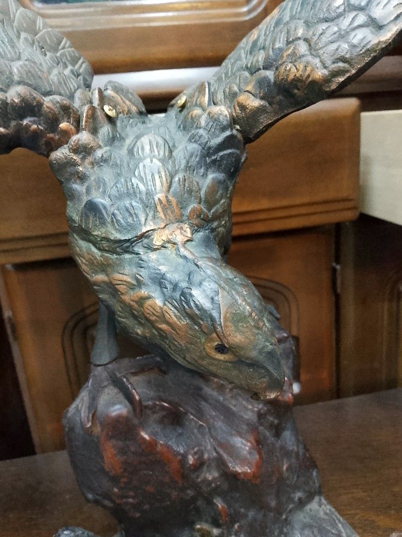 Bronze Eagle Sculpture (Category: Figurines & Statues) located in Manila. Submitted by tonisfurnitureshop (Listing ID 1394321105, Image 3). Description: - Bronze eagle sculpture - Outstretched wings - Perched on a rocky base - Detailed design - Weathered appearance - Dark brown and green patina - Decorative piece.