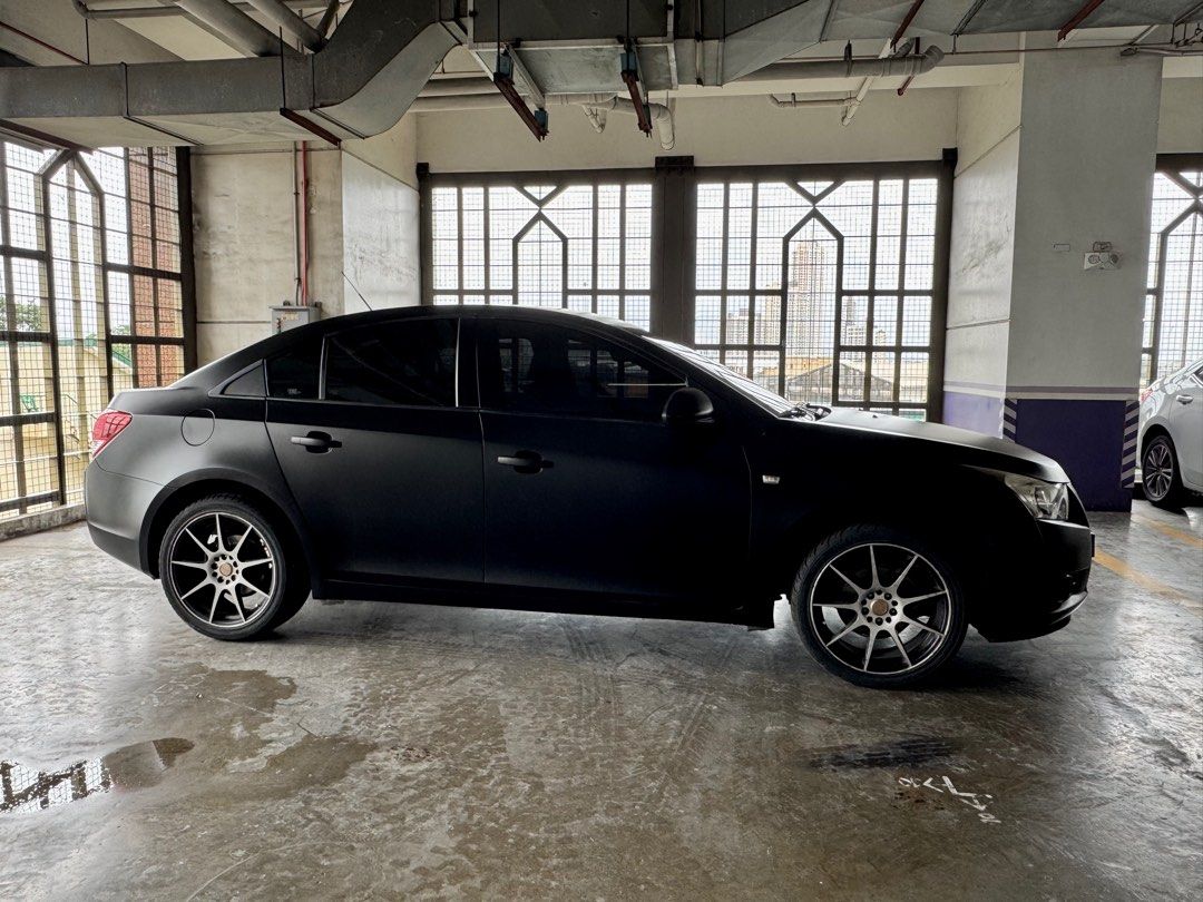 Chevrolet Cruze 1.8 LT (A) (Category: Used Cars) located in Quezon City. Submitted by prinscessa (Listing ID 1394262135, Image 3). Description: • 87,000km mileage • 1.8L 4-cylinder DOHC engine • 6-speed automatic transmission • Front and rear disc brakes with ABS • Wrapped in satin/matte black finish • Android Auto + Apple CarPlay • Upgraded touchscreen infotainment • 70mai rearview dashcam S500 set • 6-speaker audio system • Full detailing (inte
