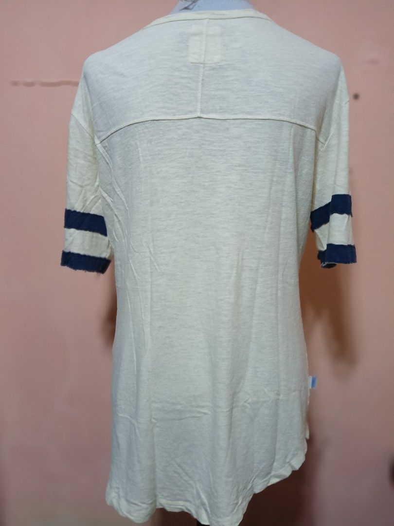 Franklin & Marshall Baseball League T-shirt (Category: Tshirts & Polo Shirts ) located in Manila. Submitted by queenv_22 (Listing ID 1394299522, Image 3). Description: Cream-colored Franklin & Marshall T-shirt with navy blue stripes on the sleeves. Features a keyhole neckline and a large "Franklin and Marshall" graphic on the front. The shirt also has text that reads "The best in Sportswear, Original, Genuine, Authentic, Since day's, BASEBALL LEA