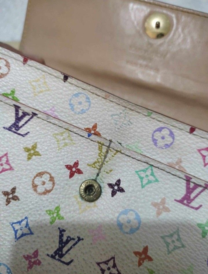 Louis Vuitton Multicolor Wallet (Category: Luxury Bags & Wallets) located in Manila. Submitted by selling.ph (Listing ID 1394401967, Image 3). Description: - Authentic Louis Vuitton multicolor wallet - Snap closure - Multiple compartments, including a zippered pocket - Comes with box, dust bag, paperwork, and shopping bag - Features the iconic Louis Vuitton multicolor pattern issue: snap button.