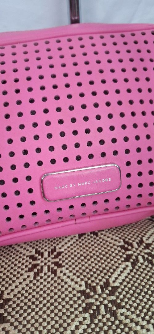 Marc by Marc Jacobs Perforated Crossbody Bag (Category: Luxury Bags & Wallets) located in Baguio. Submitted by rhaizen_ukay (Listing ID 1394220711, Image 3). Description: - Pink Marc by Marc Jacobs crossbody bag - Perforated design - Zip closure - Long strap for shoulder/crossbody wear - Pink interior with small pocket - Metal zipper and hardware.
