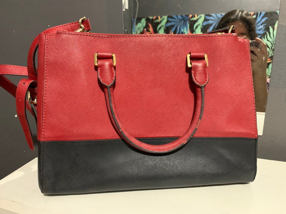 Michael Kors Sutton Red and Black Satchel Bag (Category: Luxury Bags & Wallets) located in San Juan City. Submitted by petitboop (Listing ID 1394356345, Image 2). Description: Please see photos for flaws! - Authentic - Some cracks on the leather - Lipstick stains inside the front compartment - Chipped leather strap - Unused for a long time so it kinda smells like my cabinet - Needs cleaning!.