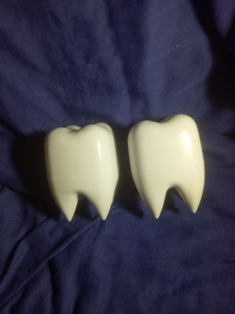 Tooth Dispenser / Toothbrush Holder/ Pen Holder (Category: Pitchers & Dispensers) located in Makati City. Submitted by buyingblind (Listing ID 1394281996, Image 3). Description: -Has slight discoloration from where sticker was; previously for giveaway but got stockpiled instead -Original price: Around Php 110; now 80 each - Set of two tooth-shaped dispensers - White dispensers with a hole on top - Designed for pens or small items - Comes with col