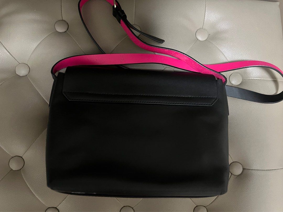 Authentic Kate Spade Black and Pink Handbag (Category: Luxury Bags & Wallets) located in Quezon City. Submitted by xxccc92 (Listing ID 1394516856, Image 3). Description: - Black Kate Spade handbag - Pink interior - Adjustable strap - Flap closure with gold-tone logo - Interior pocket - Leather material.