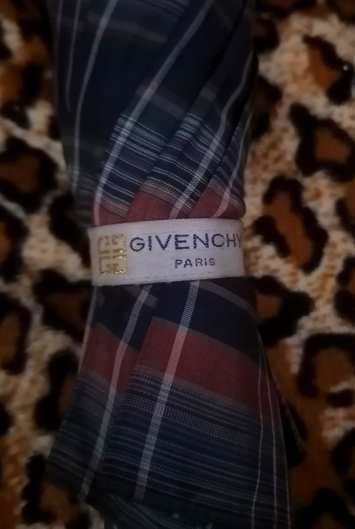 Givenchy Plaid Umbrella (Category: Umbrellas) located in Cebu City. Submitted by roadthrift (Listing ID 1394406329, Image 2). Description: - Givenchy plaid umbrella - Classic plaid pattern in blue, green, and red - Black handle with Givenchy logo - Folds up for easy storage - Givenchy logo on the interior - Stylish accessory for rainy days.
