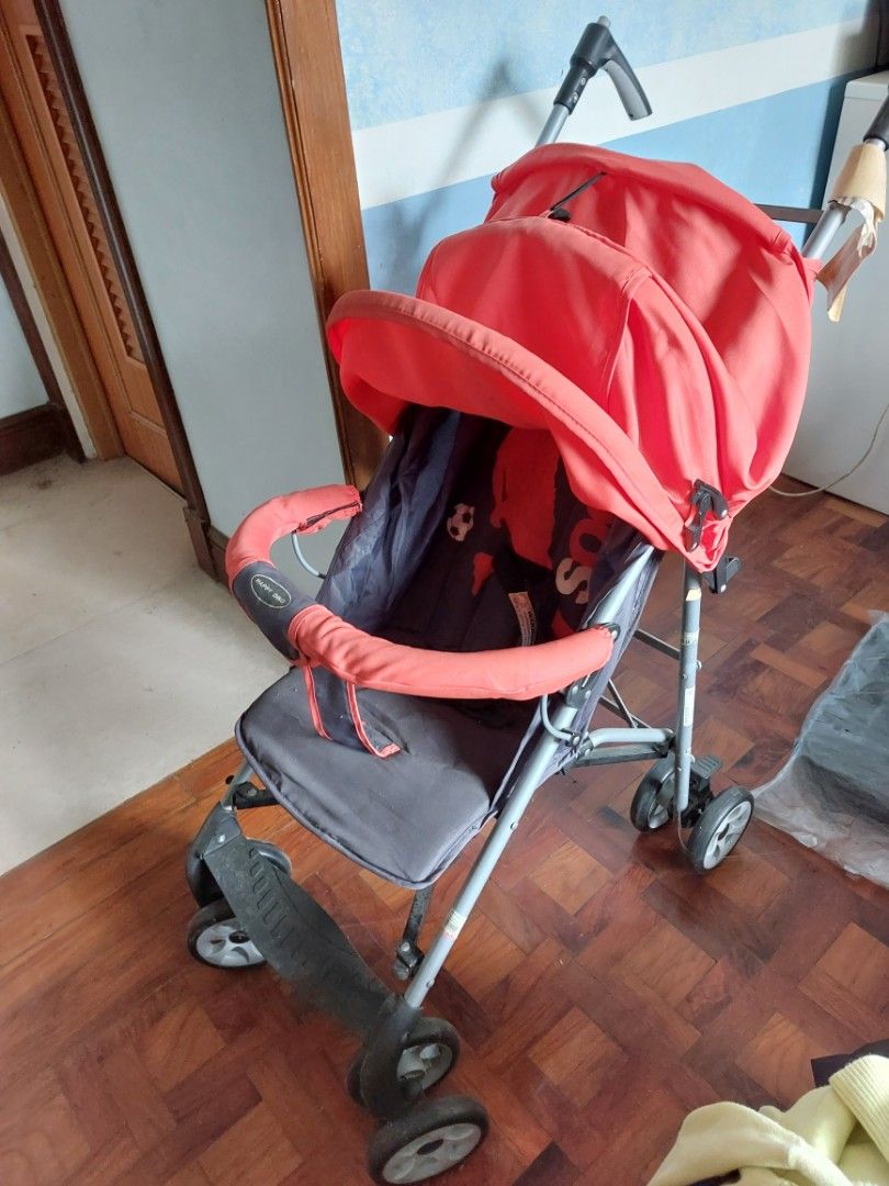 Happy Dino Baby Stroller with Red Canopy (Category: Strollers) located in Rizal. Submitted by Babyfume (Listing ID 1394431806, Image 1). Description: - Red canopy - Dark grey seat - Foldable for easy storage and transport - Multiple wheels for stability - Beige handle.