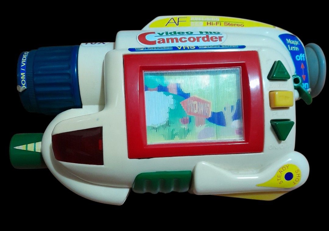 Kid Cam Video Hit Camcorder Toy (Category: Cameras) located in Mandaluyong City. Submitted by twixie94147 (Listing ID 1394489417, Image 3). Description: - Battery-operated Kid Cam camcorder toy - Full-motion zoom lens - Moving screen - Kaleidoscope function - Includes one mini-tape - Box displays features and functions - Zoom in/out capability.
