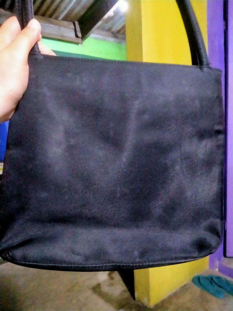 Marithe Francois Girbaud Black Handbag (Category: Luxury Bags & Wallets) located in Manila. Submitted by vanilla_sandalwood (Listing ID 1394562950, Image 2). Description: - Black Marithe Francois Girbaud handbag - Rectangular shape - Dual top handles - Main compartment with zipper closure - Interior pocket - Brand name visible - Silver-tone metal detail - Lined interior -sign of used sa corner po at sa ilalim good pa sa loob at handle,may stain n