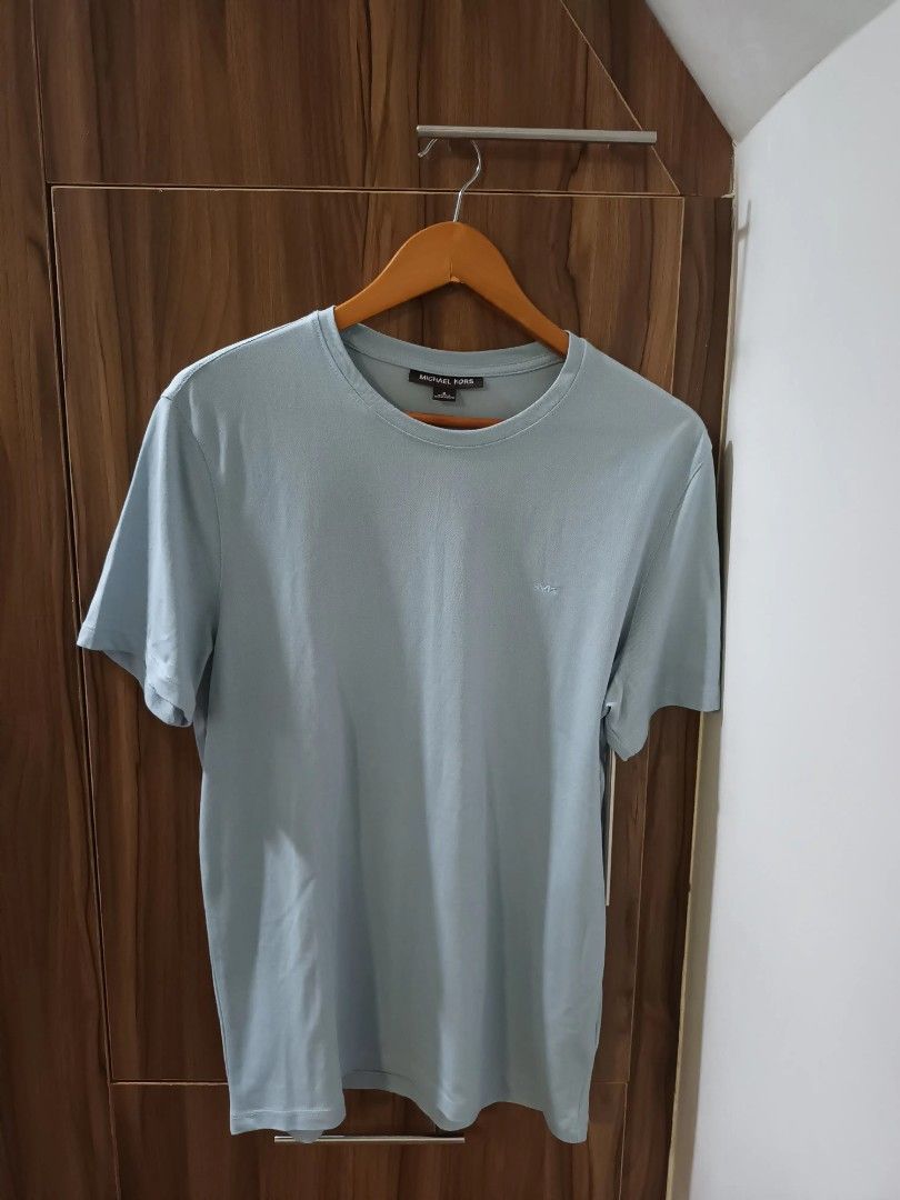 Michael Kors Light Blue T-shirt - Size M (Category: Tshirts & Polo Shirts ) located in Paranaque City. Submitted by maria_2010 (Listing ID 1394434701, Image 1). Description: Washed, unused - Light blue color - Made in Bangladesh - Short sleeves - Crew neck - Features the Michael Kors logo.