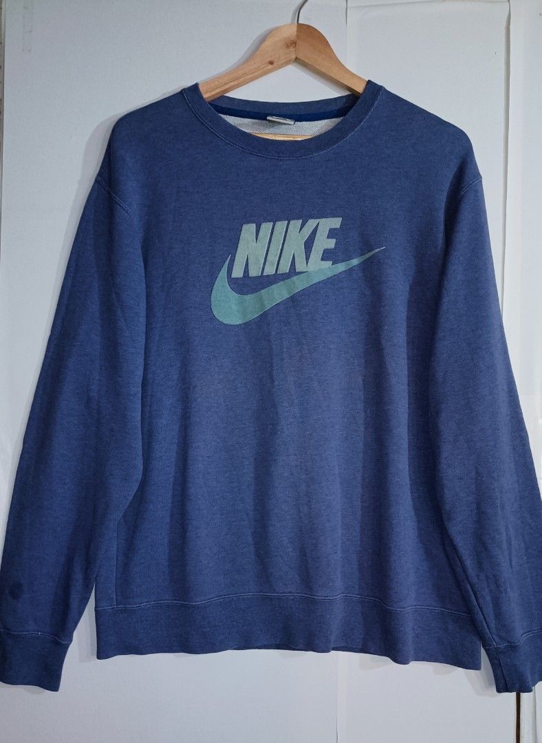 Nike Crewneck Sweatshirt - Blue (Category: Coats, Jackets and Outerwear) located in Quezon City. Submitted by selectorsthrift (Listing ID 1394561728, Image 1). Description: - Nike crewneck sweatshirt - Size: L - Color: Blue with light blue logo - Material: 100% cotton - Made in China - Manufacturing Date: 2007.
