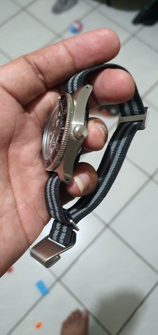 Seiko Mod 62mas Watch with Black Dial (Category: Luxury Watches) located in Lapu Lapu. Submitted by watchenthusiast4444 (Listing ID 1394430704, Image 3). Description: - Seiko watch with a black dial Seiko nh35 Automatic movement - Luminous hands and markers - Rotating bezel - Black and gray striped NATO strap - Stainless steel case - Date display at 3 o'clock.