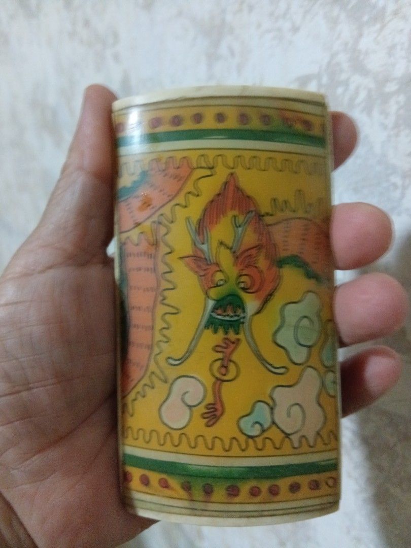 Vintage IVO bone Dragon and Rabbit Decorated display (Category: Vintage Collectibles) located in Quezon City. Submitted by threetwotwo2ndaccount (Listing ID 1394408362, Image 1). Description: - Vintage ivo bone dragon and rabbit artwork. - Cylindrical shape with a curved top. - Features detailed, vibrant artwork. - Made of a light-colored material (possibly bone). - Unique and decorative design..