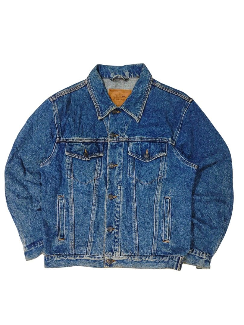 Calvin Klein Denim Jacket (Category: Coats, Jackets and Outerwear) located in Dapitan. Submitted by vincesabejon (Listing ID 1394605558, Image 1). Description: Length: 21 Width: 25 Condition: Excellent Condition No Flaws♻️ Need Wash 📐Fits Medium To Large - Calvin Klein denim jacket - Medium wash - Button-down closure - Two chest pockets - Collared neckline - Calvin Klein label visible - A timeless wardrobe staple.