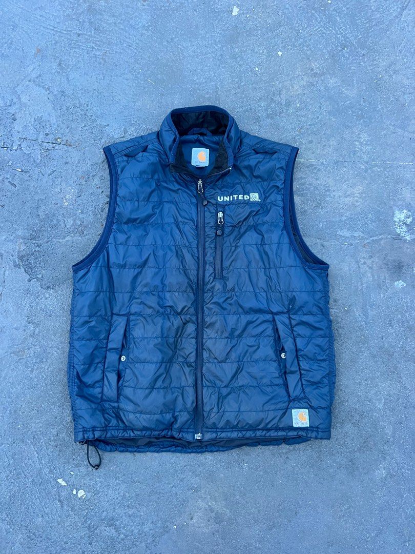 Carhartt United Vest, (Category: Vests) located in Manila. Submitted by muskelon (Listing ID 1394619790, Image 2). Description: - Navy blue Carhartt vest - Full zip closure - Features: - Small chest pocket - Two side pockets - Stand-up collar - "UNITED" logo on chest - Carhartt logo on lower right - Quilted design 28 length 23.5 width no issues need wash lang .