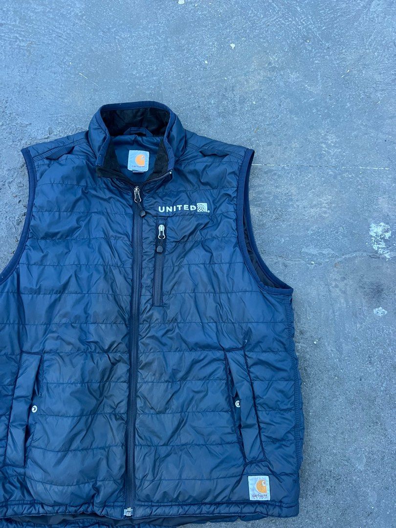 Carhartt United Vest, (Category: Vests) located in Manila. Submitted by muskelon (Listing ID 1394619790, Image 1). Description: - Navy blue Carhartt vest - Full zip closure - Features: - Small chest pocket - Two side pockets - Stand-up collar - "UNITED" logo on chest - Carhartt logo on lower right - Quilted design 28 length 23.5 width no issues need wash lang .