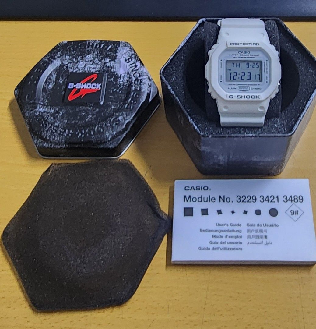 Casio G-Shock White Digital Watch DW-5600MW (Category: Men's Watches) located in Taguig. Submitted by masterbert (Listing ID 1394639455, Image 2). Description: - Casio G-Shock digital watch - White band and face - Comes with original box, packaging, and user guide - Displays time and date - Module numbers: 3229, 3421, 3489 - G-Shock logo visible.