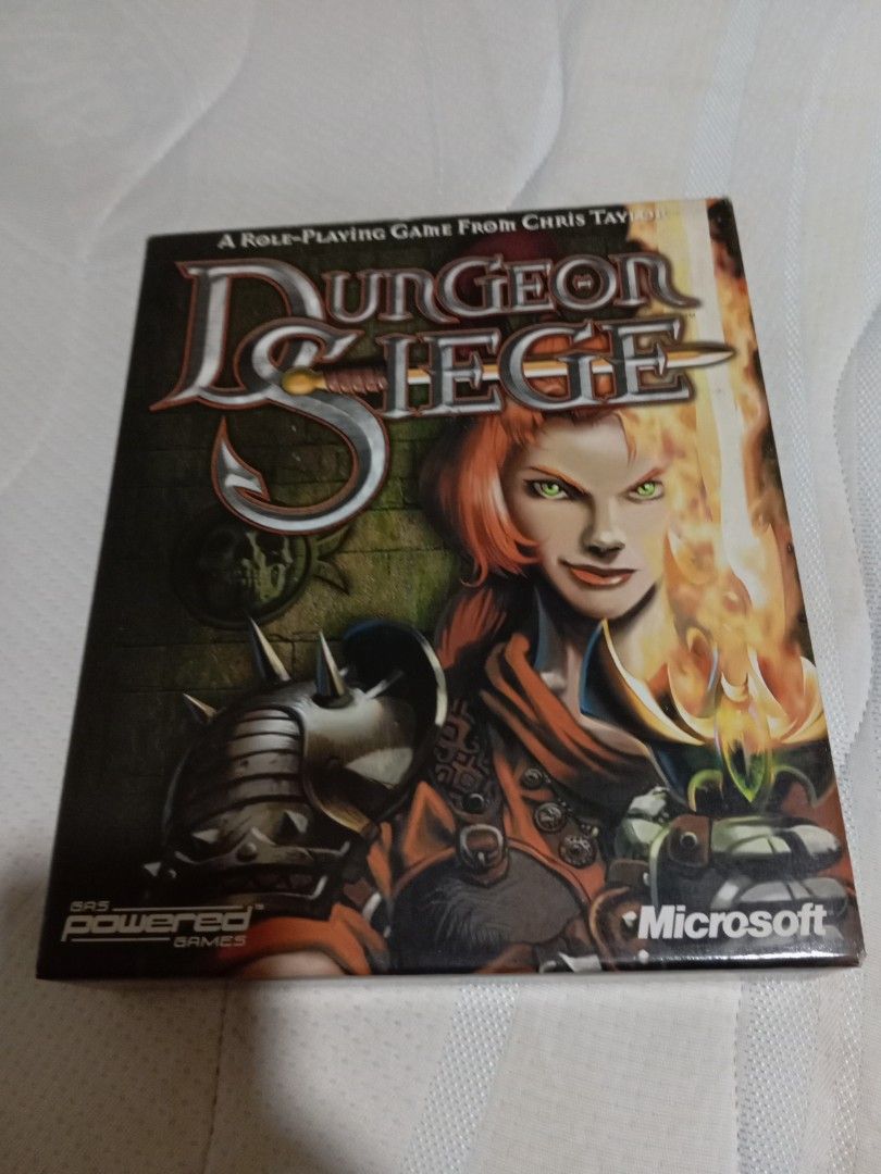 Dungeon Siege PC Game (Category: Others) located in Marikina City. Submitted by yoh6781 (Listing ID 1394730205, Image 1). Description: - Dungeon Siege PC game - Role-playing game by Chris Taylor - Published by Microsoft - Box art features a red-haired female character - Includes the game logo - Features the Gas Powered Games logo.