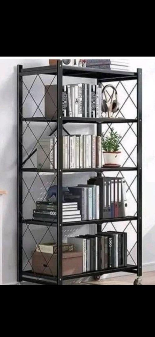 Foldable 5-Tier Bookshelf (Category: Shelves, Cabinets & Racks) located in Quezon City. Submitted by henco (Listing ID 1394605687, Image 1). Description: - 5-tier foldable bookshelf - Black metal frame with diamond design - Dark-colored shelves - Equipped with wheels for easy movement - Ideal for books, plants, and various items - pls call for fast transaction 09279957180.