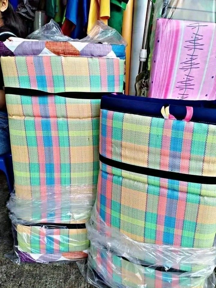 Foldable Foam Mattress Thin Banig (Category: Bed Frames & Mattresses) located in Caloocan City. Submitted by surplusandbnewshop (Listing ID 1394694732, Image 3). Description: Foldable foam mattress with thin banig. Available in single, double, queen, and king sizes. The mattress has colorful striped patterns. It is wrapped in plastic for protection. The images show different patterns and colors. The mattress is suitable for sleeping or lounging..
