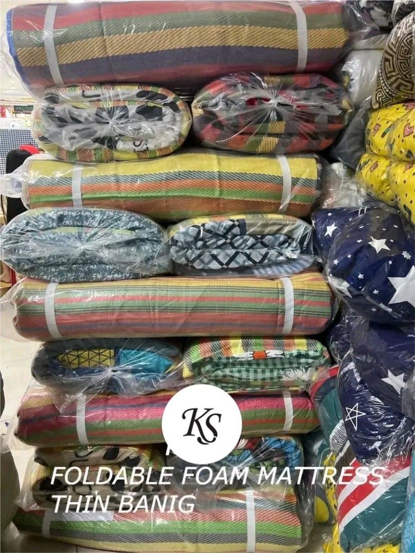 Foldable Foam Mattress Thin Banig (Category: Bed Frames & Mattresses) located in Caloocan City. Submitted by surplusandbnewshop (Listing ID 1394694732, Image 2). Description: Foldable foam mattress with thin banig. Available in single, double, queen, and king sizes. The mattress has colorful striped patterns. It is wrapped in plastic for protection. The images show different patterns and colors. The mattress is suitable for sleeping or lounging..
