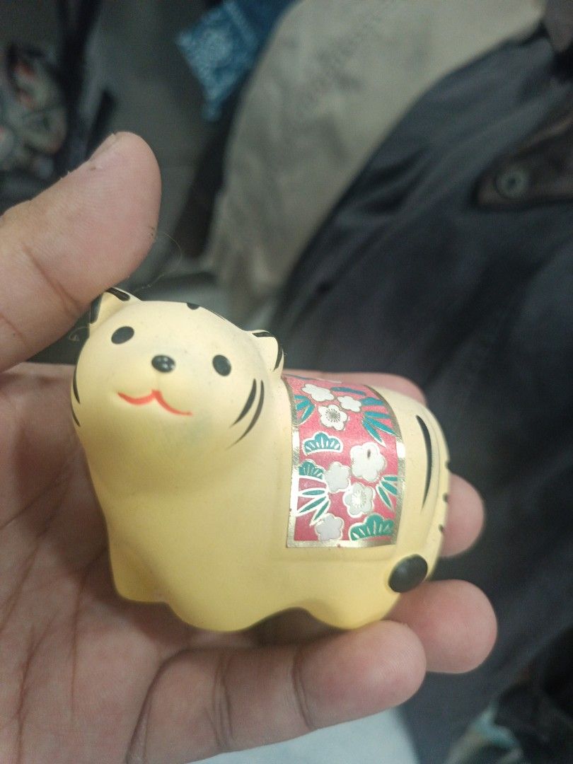 Japanese Ceramic Tiger Figurine (Category: Other Home Decor) located in Quezon City. Submitted by bjetp (Listing ID 1394763896, Image 1). Description: - Adorable ceramic tiger figurine - Features a charming floral design - Painted in soft yellow with black stripes - Cute, smiling face - Ideal decorative piece moving out.