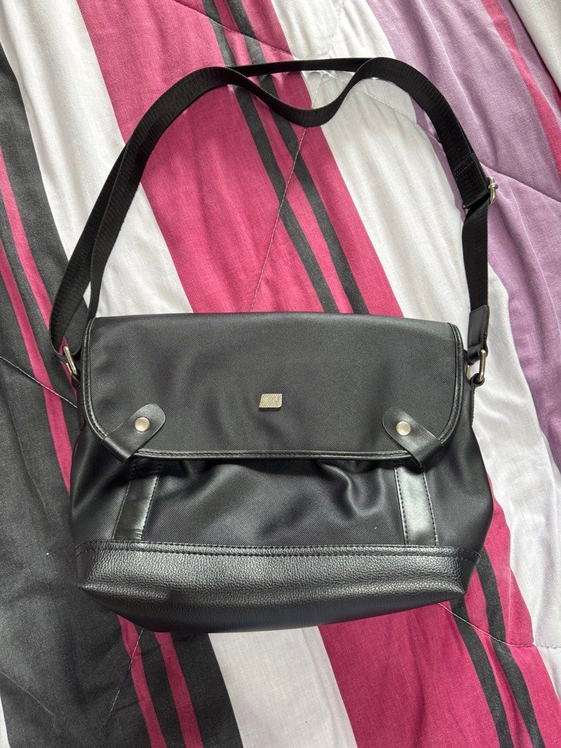 MCJIM Black Crossbody Messenger Bag (Category: Cross-body Bags) located in Manila. Submitted by beatrice777 (Listing ID 1394659259, Image 1). Description: Original Price: ₱1,500 No other issues except sa flap ng bag (see listed pictures).