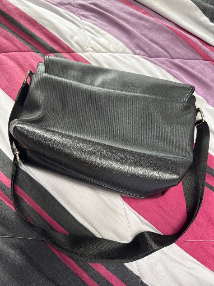 MCJIM Black Crossbody Messenger Bag (Category: Cross-body Bags) located in Manila. Submitted by beatrice777 (Listing ID 1394659259, Image 2). Description: Original Price: ₱1,500 No other issues except sa flap ng bag (see listed pictures).