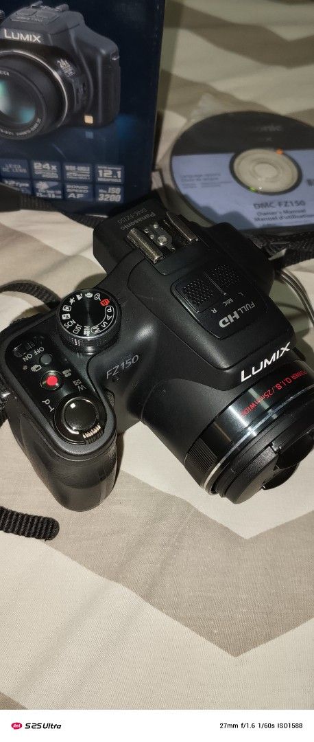 Panasonic Lumix DMC-FZ150 Digital Camera (Category: Cameras) located in Quezon City. Submitted by expe888 (Listing ID 1394772858, Image 2). Description: - Panasonic Lumix DMC-FZ150 digital camera - Includes original box - Comes with charger and accessories - Black camera - Model: DMC-FZ150PUK - Lens cap and strap included.