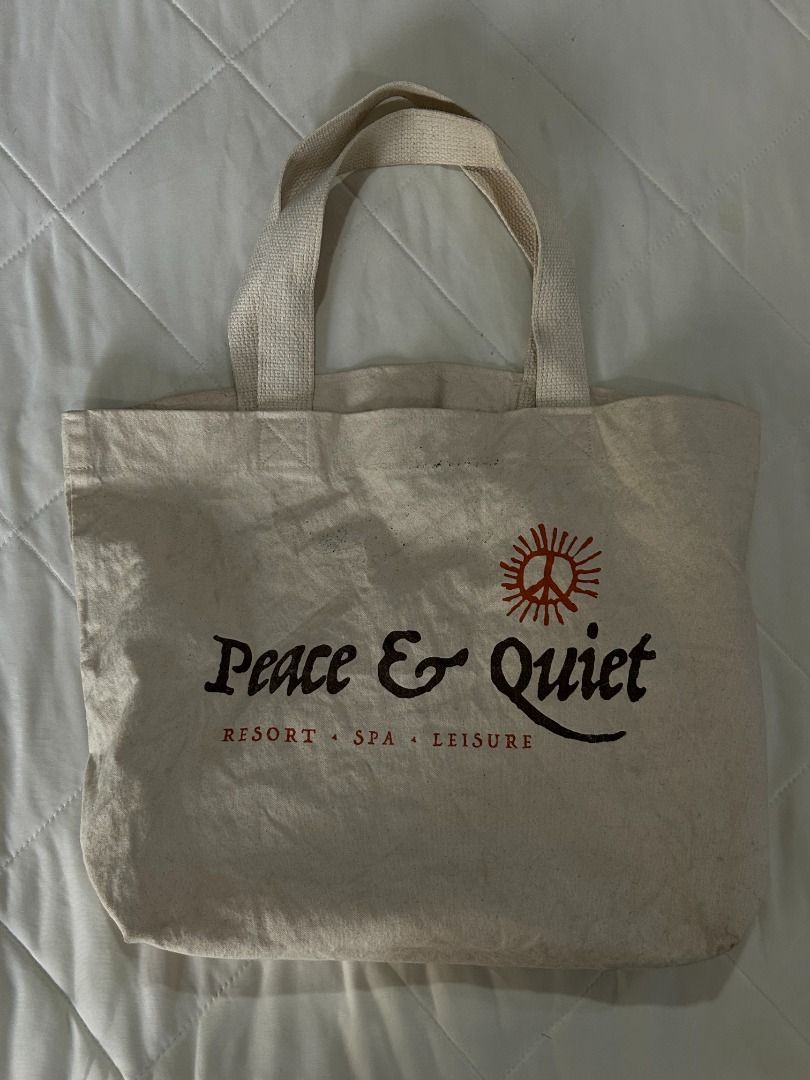 Peace & Quiet Resort Tote Bag (Category: Tote Bags) located in Manila. Submitted by decluttteringz (Listing ID 1394612285, Image 1). Description: - Peace & Quiet resort logo tote bag - Features two handles - Made of light-colored fabric - Rectangular shape - Spacious design - Plain back - Ideal for carrying various items.