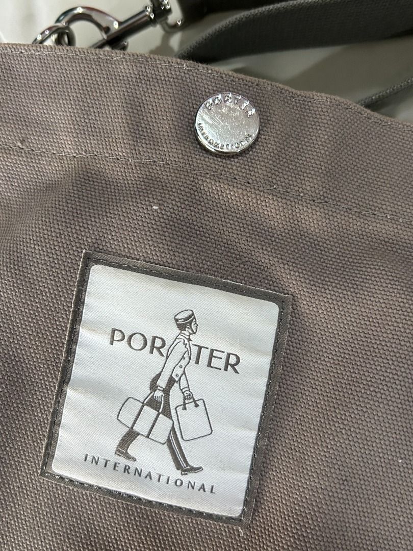 Porter International Shoulder Bag (Category: Shoulder Bags) located in Manila. Submitted by decluttteringz (Listing ID 1394611858, Image 2). Description: - Porter International shoulder bag - Main compartment with zipper closure - Adjustable shoulder strap - Small inner pocket - Neutral color - Porter International logo on front - Button closure on front.