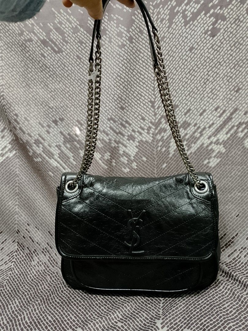 Saint Laurent Nikki (Category: Luxury Bags & Wallets) located in Baguio. Submitted by luxuryitems08 (Listing ID 1394654302, Image 1). Description: -YSL Nikki - Classic black color -coded - Flap closure - Silver chain strap - Saint Laurent logo detail - Interior zippered pocket - Includes brand tag: "Made in Italy".