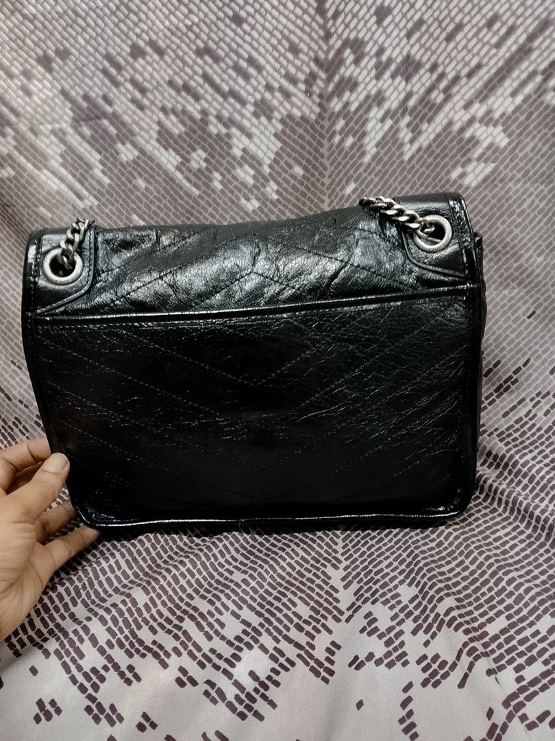 Saint Laurent Nikki (Category: Luxury Bags & Wallets) located in Baguio. Submitted by luxuryitems08 (Listing ID 1394654302, Image 2). Description: -YSL Nikki - Classic black color -coded - Flap closure - Silver chain strap - Saint Laurent logo detail - Interior zippered pocket - Includes brand tag: "Made in Italy".
