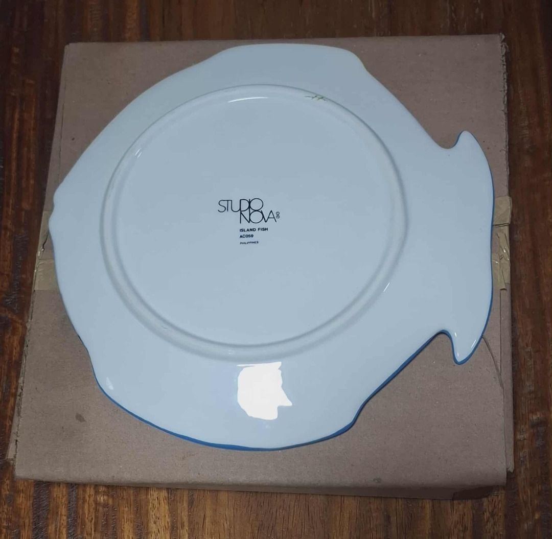 Studio Nova Reef Fish Plate (Category: Other Kitchenware & Tableware) located in Quezon City. Submitted by m_decluttering_sale (Listing ID 1394709301, Image 2). Description: Studio Nova Reef Fish Decorative Plate – Collectible 🐠✨ Brand: Studio Nova Design/Pattern: Reef Fish (Hand-painted style) Material: Ceramic/Porcelain Shape: Fish-shaped plate Colors: Yellow base with accents of blue, black, peach, green, and orange Size: Approx. 10" diameter