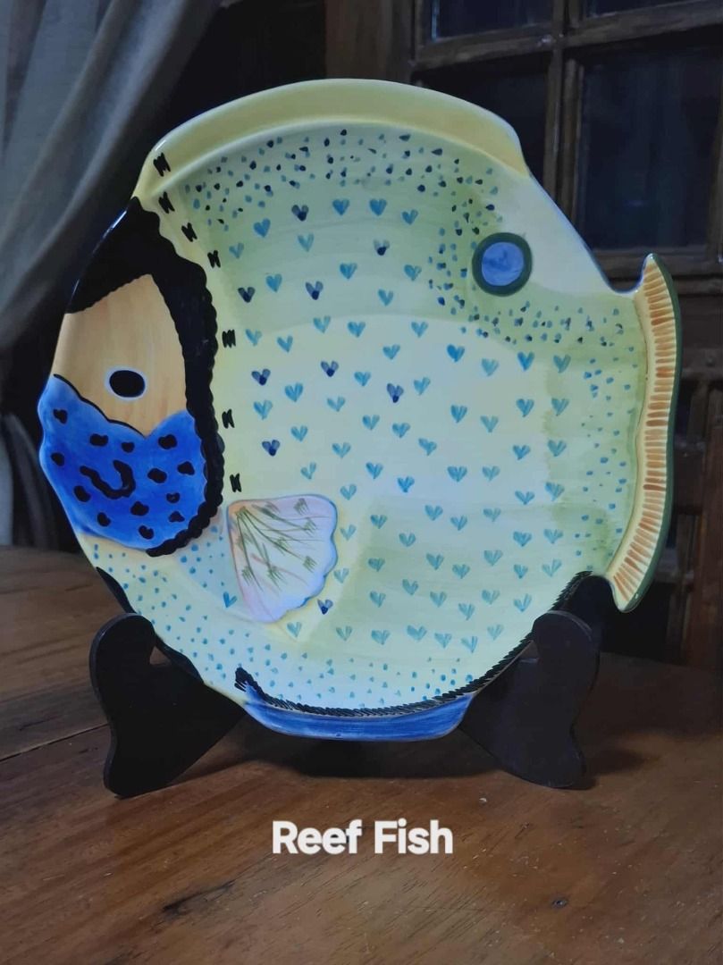 Studio Nova Reef Fish Plate (Category: Other Kitchenware & Tableware) located in Quezon City. Submitted by m_decluttering_sale (Listing ID 1394709301, Image 1). Description: Studio Nova Reef Fish Decorative Plate – Collectible 🐠✨ Brand: Studio Nova Design/Pattern: Reef Fish (Hand-painted style) Material: Ceramic/Porcelain Shape: Fish-shaped plate Colors: Yellow base with accents of blue, black, peach, green, and orange Size: Approx. 10" diameter