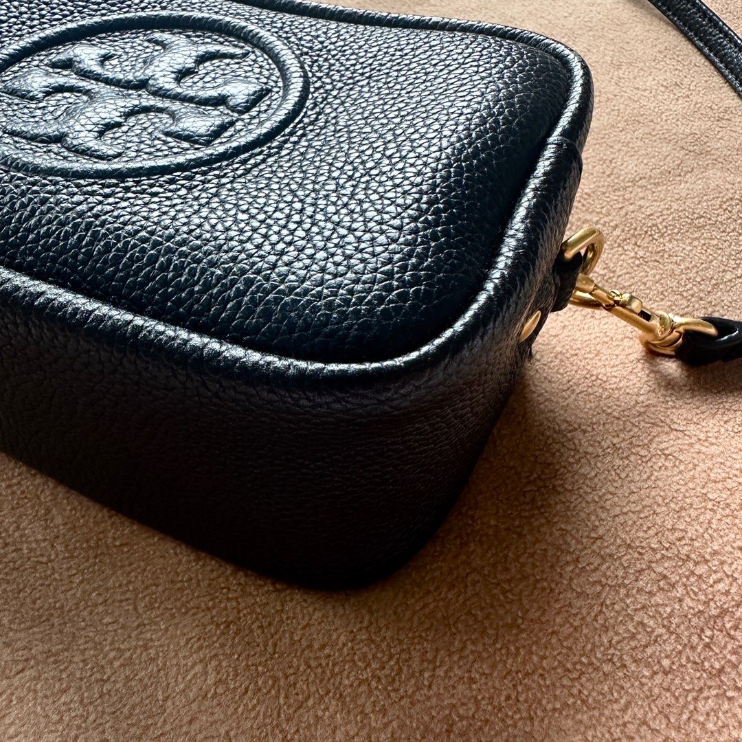 Tory Burch Perry Bombe Mini Crossbody Bag (Category: Luxury Bags & Wallets) located in Dipolog. Submitted by es_serena (Listing ID 1394641565, Image 2). Description: - Black crossbody bag - Textured finish - Tory Burch logo on front - Rectangular shape - Double-zippered top - Adjustable long strap - Gold-toned hardware (In very good condition. Barely worn. Just decluttering items. Please let me know if you are interested 😉).