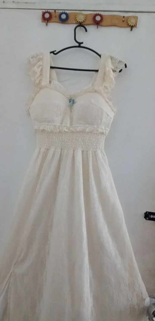 white long dress (Category: Dresses) located in Bulacan. Submitted by fadeea412 (Listing ID 1394674437, Image 1). Description: - Elegant off-white dress - Delicate ruffles and fitted bodice - Sweetheart neckline - Flowing skirt - Small blue embellishment at the bust - Ruffled straps - Perfect for special occasions.
