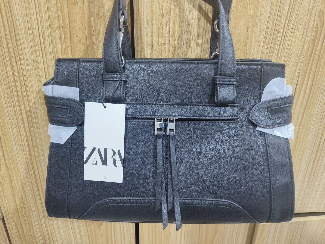 Zara Black Handbag with Shoulder Strap (Category: Shoulder Bags) located in Paranaque City. Submitted by jam8423 (Listing ID 1394761645, Image 1). Description: - Zara black handbag - Shoulder strap and top handle - Front zipper pocket with tassels - Includes dust bag - Spacious interior with zipper closure - Medium size - Authentic with Zara logo and price tag (AUD) Open for meetup, no to COD negotiable.