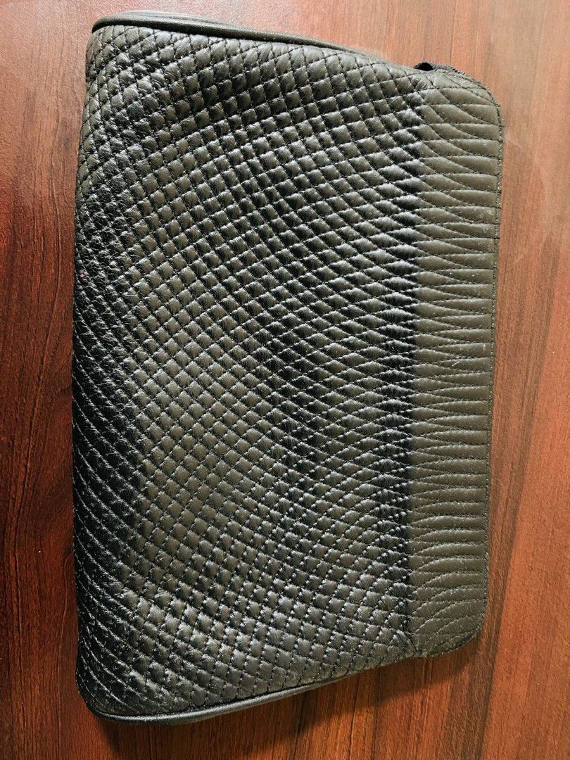 Bally Quilted Clutch (Category: Luxury Bags & Wallets) located in Rosales. Submitted by motcarest (Listing ID 1394794602, Image 3). Description: - Bally clutch with quilted design - Features a zip closure - Includes a wrist strap - Multiple interior compartments - Textured design on the back - Classic and stylish accessory.