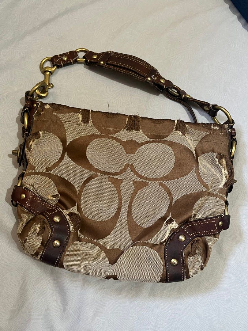 Coach Signature Hobo Bag Small (Category: Luxury Bags & Wallets) located in Lapu Lapu. Submitted by freebear-196d (Listing ID 1394962575, Image 1). Description: - Authentic Coach Signature Hobo bag - Brown and tan signature print - Brown leather accents - Top handle - Gold-tone hardware - Interior pocket with Coach label.