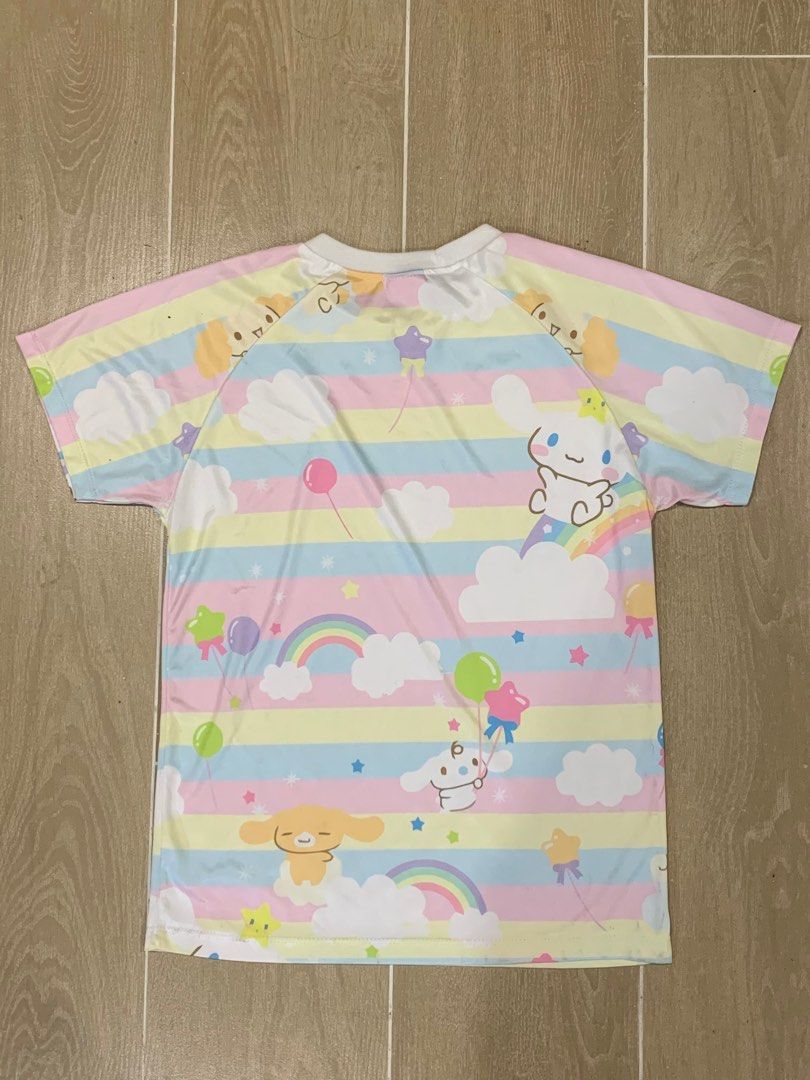 Cinnamoroll Pastel Rainbow T-shirt (Category: Shirts) located in Cavite. Submitted by ayessafe (Listing ID 1394869455, Image 2). Description: SIZE: Up to Semi-Large, breathable and stretchable fabric. - Adorable Cinnamoroll T-shirt. - Features a colorful pastel rainbow design. - Includes Cinnamoroll characters, rainbows, balloons, and stars. - Made of lightweight material. - Front and back are printed. .