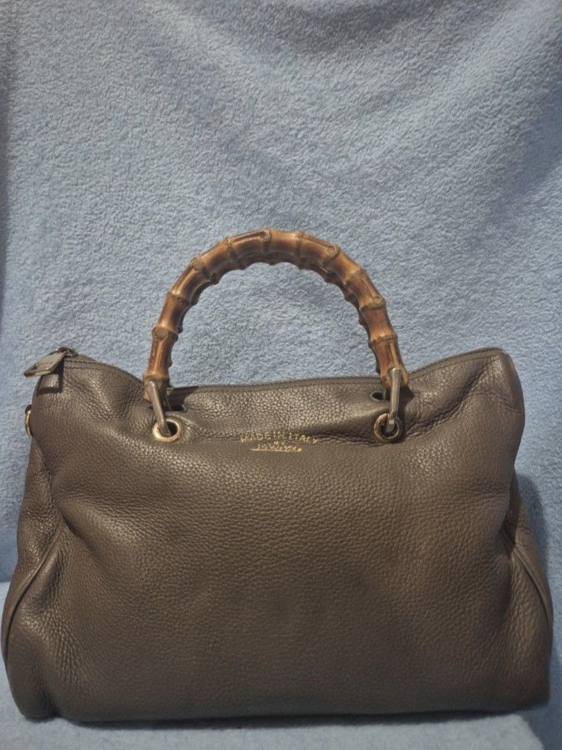 Gucci Bamboo Handle Bag (Category: Luxury Bags & Wallets) located in Valenzuela. Submitted by randomlyn (Listing ID 1394854860, Image 1). Description: - Authentic Gucci handbag - Iconic bamboo handles - Zip closure - Spacious interior with multiple compartments - Made in Italy - Leather exterior - Gucci logo and serial number inside - Detachable strap - With Entrupy.