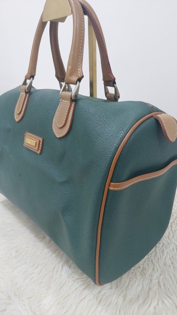 Lancel Paris Green Handbag (Category: Luxury Bags & Wallets) located in Cainta. Submitted by pouchbucketbags (Listing ID 1394903477, Image 3). Description: - Lancel Paris handbag - Striking green color with tan accents - Dual top handles - Structured design - Matching tan fabric interior - Rectangular shape - Zipper closure - Brand label visible inside - Made in France - 9"H × 7"W × 14"L .