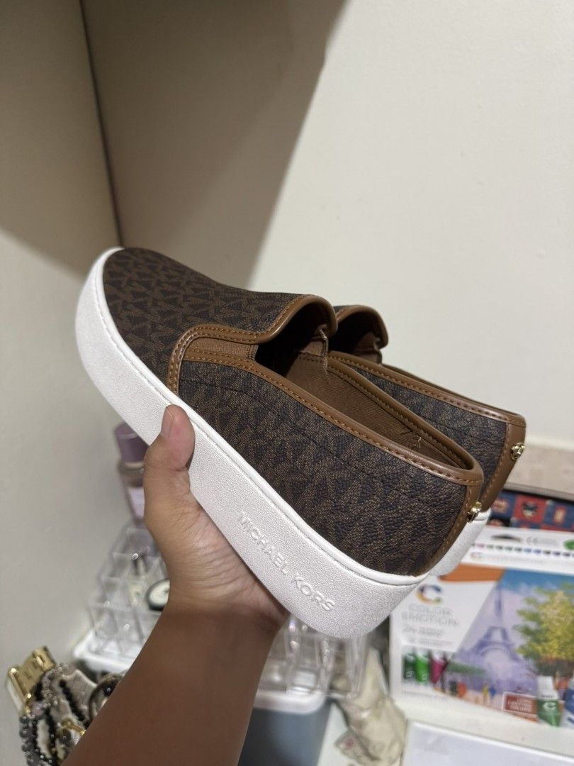 Michael Kors Teddi Logo Slip-On Platform Sneakers (Category: Casual Shoes) located in Muntinlupa City. Submitted by jmmlab (Listing ID 1394785135, Image 2). Description: - Michael Kors Teddi Logo Slip-On Platform Sneakers - Features: - Brown monogram design - White platform sole - Slip-on style - Original Price: ₱18,250 - Status: Out of Stock Rush Sale for 2,999 7M on tag bigay lang, walang size 7 sa amin kaya selling as is. Rush.