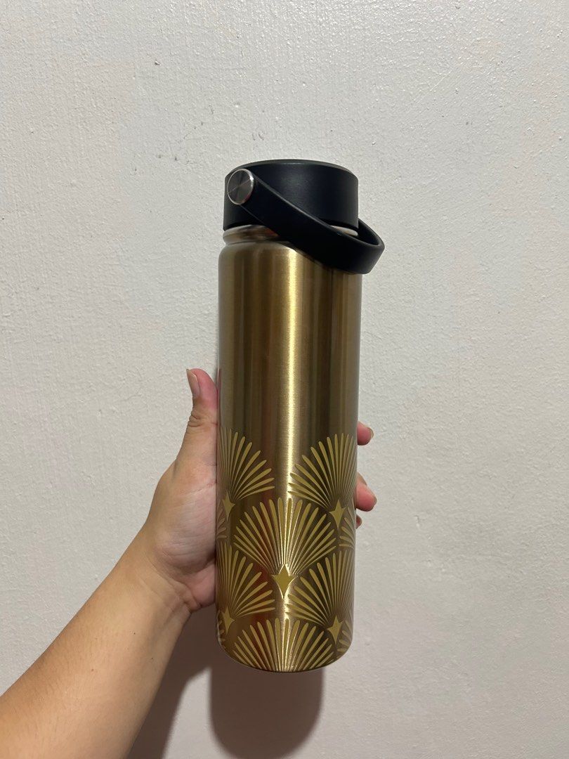 2022 CBTL Holiday your way Collection (Category: Water Bottles & Tumblers) located in Quezon City. Submitted by 47bea2b9d2c93d4bd094ba6042b4c6 (Listing ID 1395129667, Image 2). Description: - Gold-colored Coffee Bean & Tea Leaf tumbler - Black lid and handle - Decorative fan design - Comes with original box - Keeps drinks hot or cold - Stylish and practical.