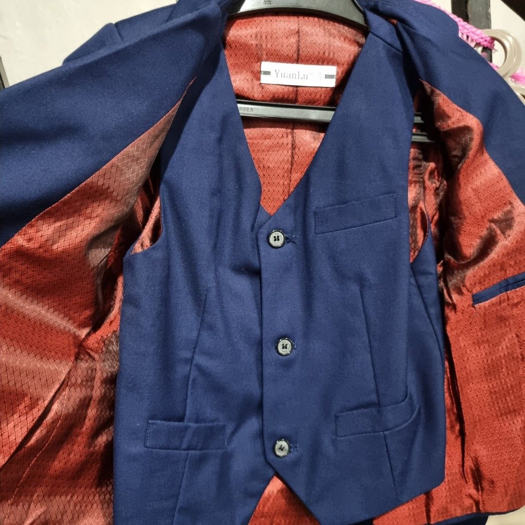4-Piece Suit for Boys (Category: Babies & Kids Fashion) located in Makati City. Submitted by PeppermintPanda (Listing ID 1394846946, Image 2). Description: - Bought for 2k+ - Navy blue 4-piece suit - Includes blazer, vest, long sleeves and pants - Vest: 3 buttons, 2 pockets - Blazer: 2 buttons, 2 pockets - Red lining - Pants: Button and zipper closure, adjustable waist size.