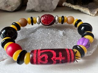 Tibetan saffron offering vase. Hand chain with ancient dzi bead featuring auspicious patterns64221546791810110